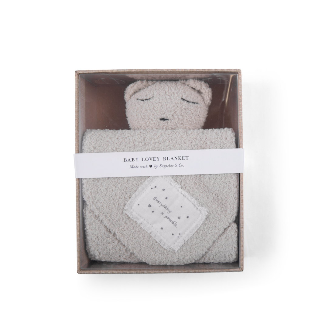a white Bear Baby Lovey Blanket in a box